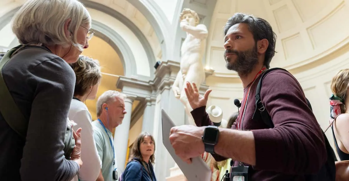 Guided tour group admiring Michelangelo's David at the Accademia, one of the museums in Florence, Italy