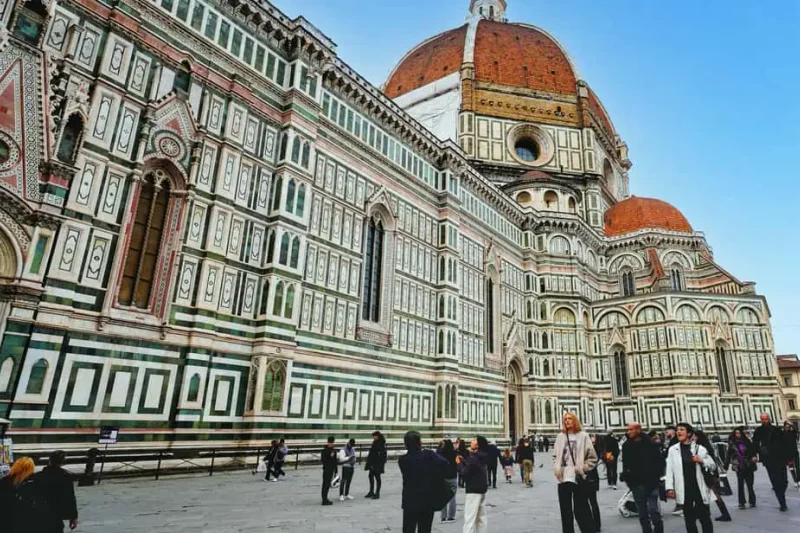 The marble facade and red-tiled dome of Florence Cathedral, the landmark among the museums in Florence, Italy