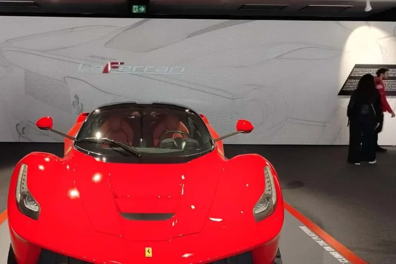 A red Ferrari on display at the Museo Enzo Ferrari in Modena, a day trip from the museums in Florence, Italy