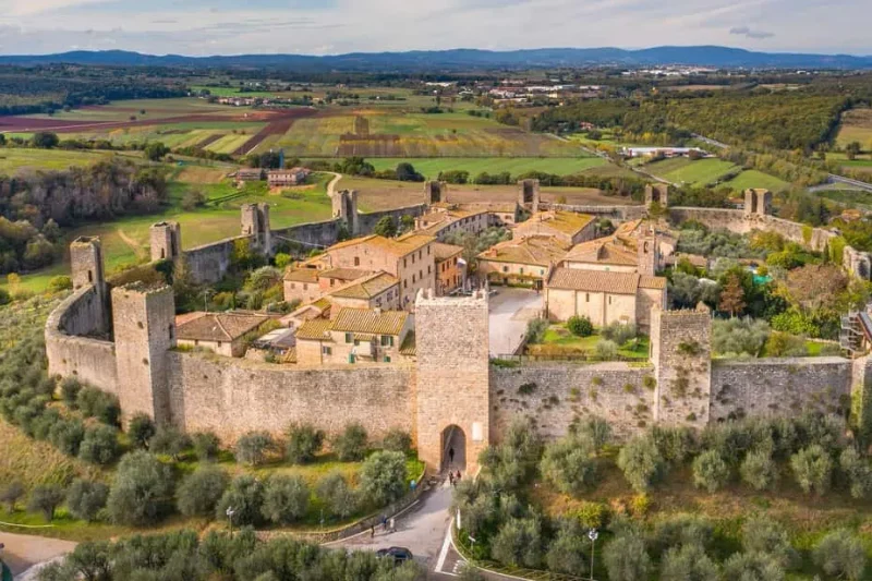 The intact walls and towers of Monteriggioni in the Tuscan hills, a day trip from the museums in Florence, Italy