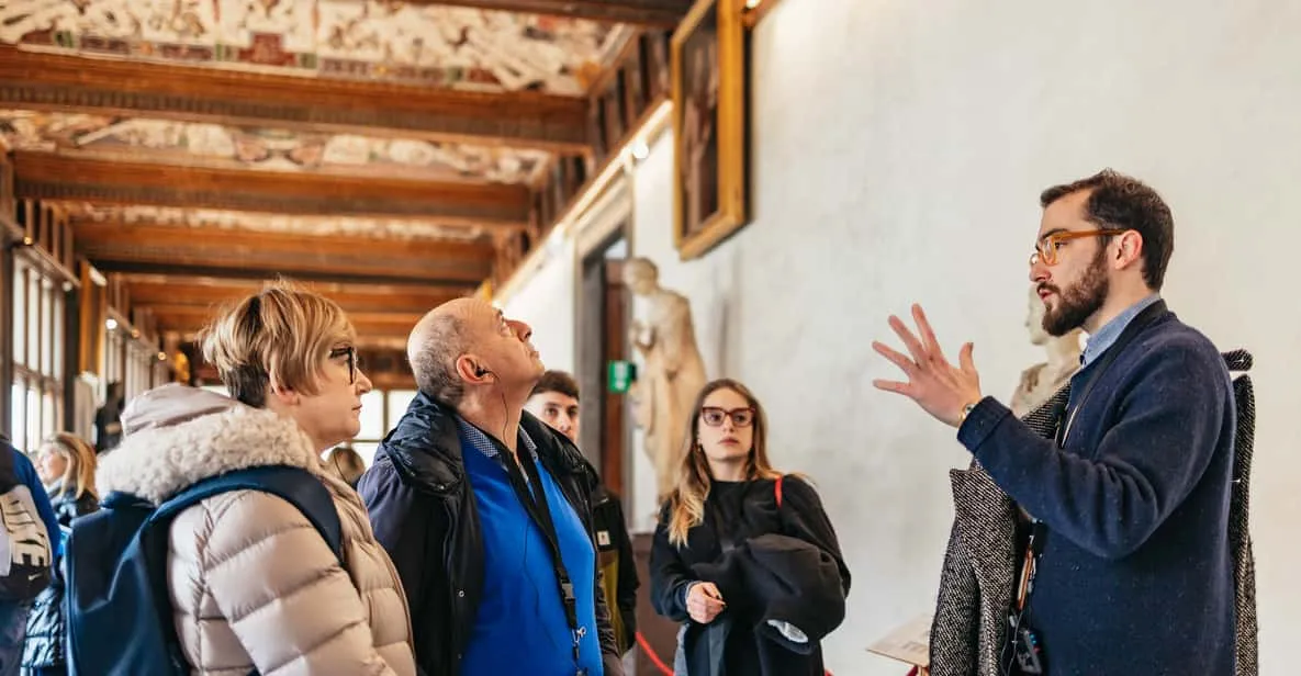 Guided group viewing Renaissance paintings in the Uffizi corridor, a highlight of the museums in Florence, Italy
