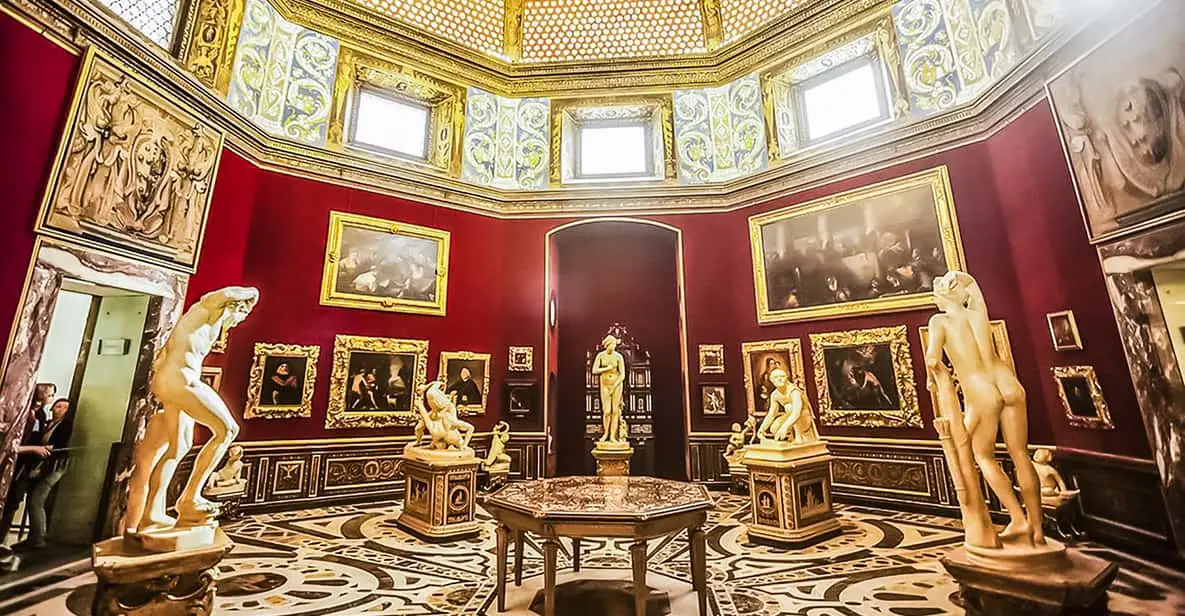 The Uffizi Gallery interior with visitors viewing paintings, one of the essential museums in Florence, Italy